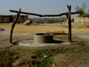 A Well with Wheat Drying Behind It